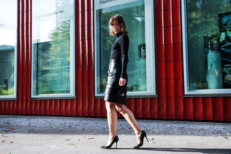 sonrisa in a black leather vintige skirt by versage and heels